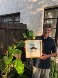 David Futch holding painting of the Boca Grande Lighthouse