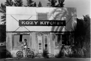 Black and White photo of restaurant with Kozy Kitchen sign