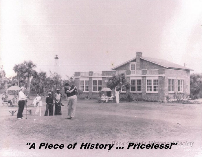 Black and white photo of golfers in front of a brick building.