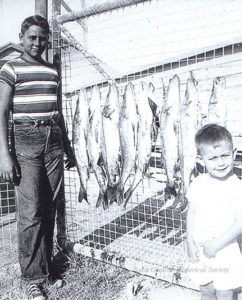 Bell family with their snook catch at the phosphate dock gate. Charles Bell, age 12 on left with Milton Bell, age 3 on right.