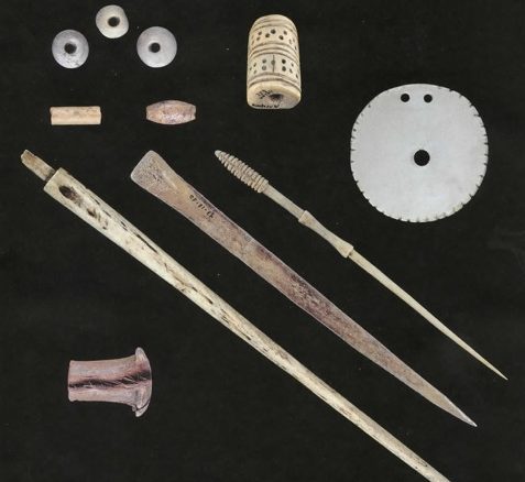 The Calusa used artifacts such as shell and bone beads, top left, bone pins, middle, and wooden ear plugs, bottom left.