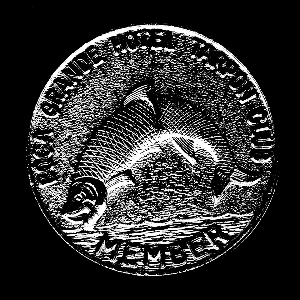 grayscale photo of a Boca Grande Tarpon Club coin