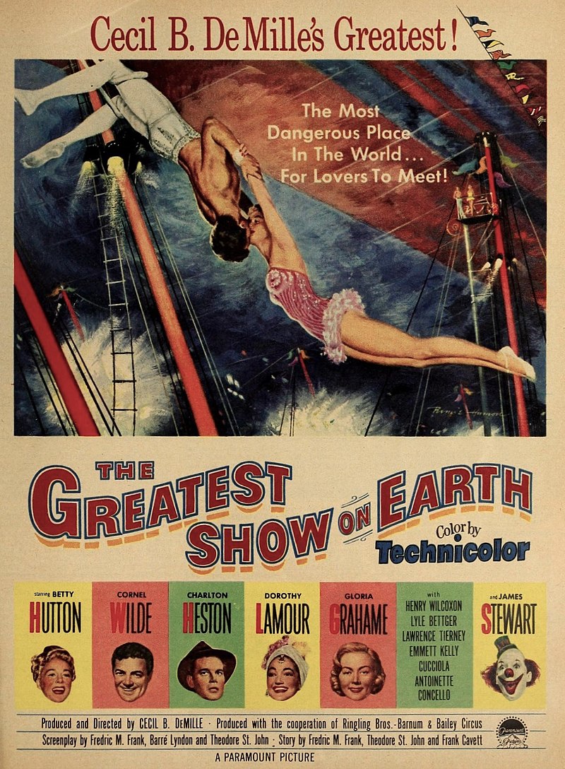 movie poster for Cecil B. DeMille's The Greatest Show on Earth. Poster depicts a male and female acrobat kissing with the headline The Most Dangerous Place in the World for Lovers to Meet