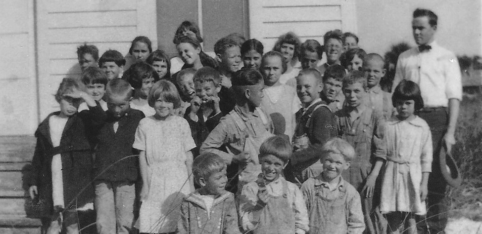 a group of schoolchildren and their teacher in front of the Gasparilla School in 1923