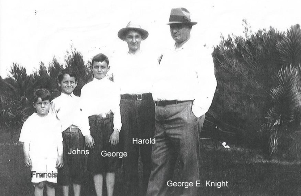 black and white photograph of George E. Knight and his sons wearing white shirts and standing in a row