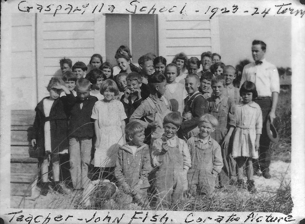 a group of young children and their teacher, John Fish, standing outside Gasparilla School in 1923