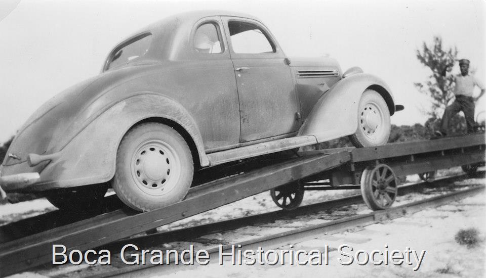 1937 Photograph of a car being loaded onto a trailer