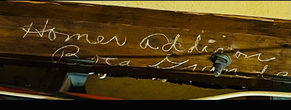 a name and location inscribed into a wood ceiling